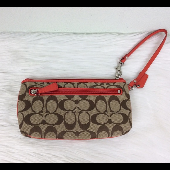 Coach logo wristlet accented with a deep orange. - Picture 2 of 7